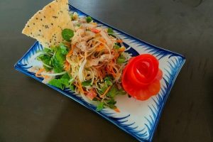 Vietnamese papaya salad served on a decorative plate