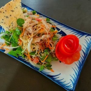 Vietnamese papaya salad served on a decorative plate