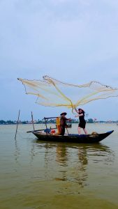 Basket boat tour with local fisherman casting a net in Hoi An