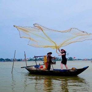 Basket boat tour with local fisherman casting a net in Hoi An