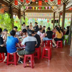 Tour group enjoying local food in Hoi An.