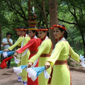 Vietnamese women performing a traditional fan dance outdoors