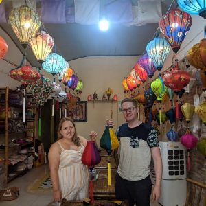 Visitors holding traditional lanterns in a Hoi An lantern workshop
