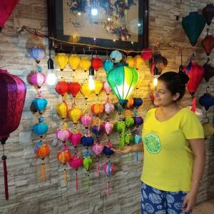Woman viewing colorful traditional lanterns in Hoi An