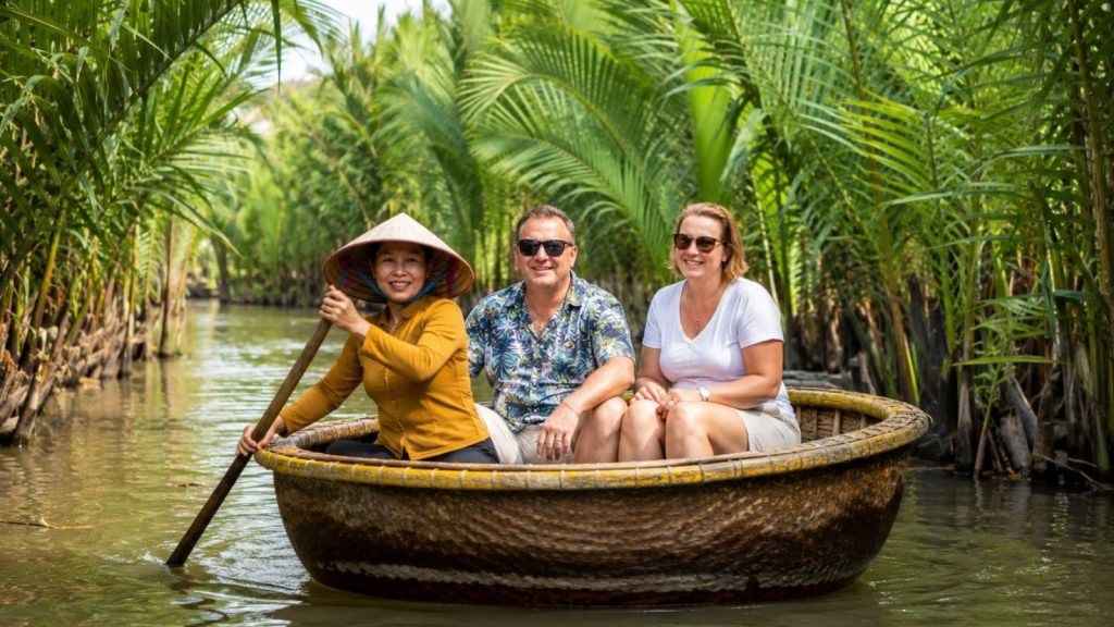 Best Cam Thanh Coconut Village Tour for a Unique Hoi An Experience 4 Local guide rowing tourists in a basket boat through Cam Thanh Coconut Village.