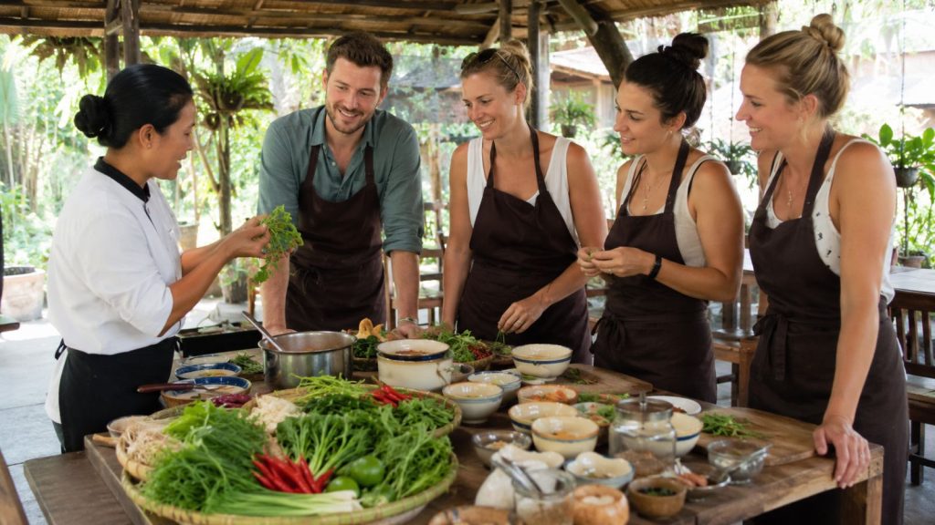 Travelers join a hands-on Vietnamese cooking class with fresh herbs and local ingredients in Cam Thanh Village.