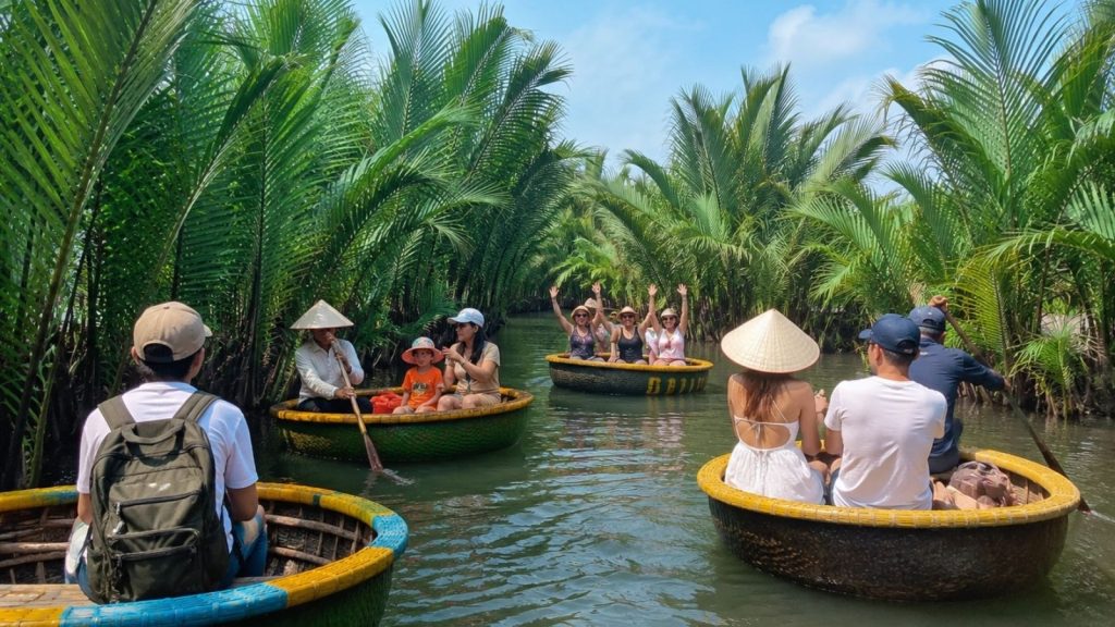 Tourists enjoying a basket boat ride under coconut palms in Hoi An.