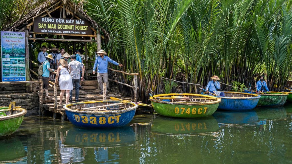 Visitors boarding basket boats at the Bay Mau Coconut Forest tour entrance in Hoi An.