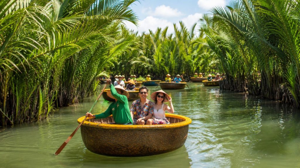 Hoi An day itinerary with coconut boat tour booking confirmation, map, sunglasses, and travel essentials.