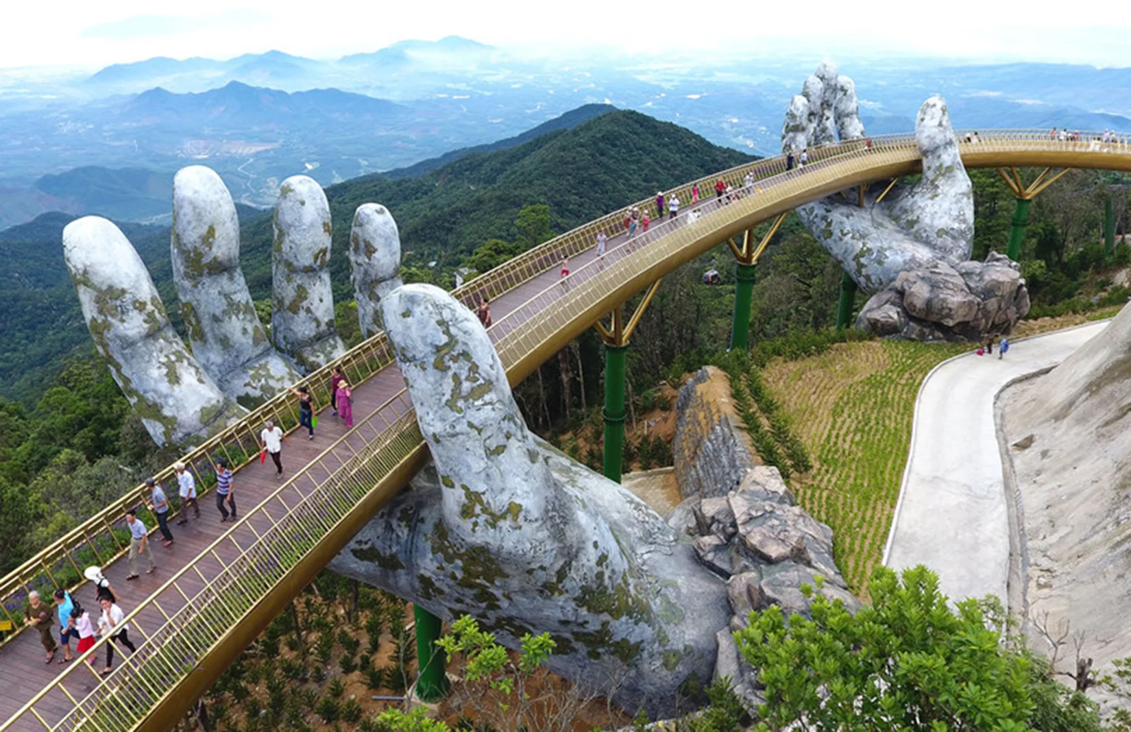 Top 10 Day Trips from Da Nang for International Tourists 2 The iconic Golden Bridge held by giant stone hands at Ba Na Hills theme park near Da Nang Vietnam