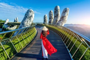 The iconic Golden Bridge (Cau Vang) at Ba Na Hills held by giant stone hands above the clouds near Da Nang Vietnam