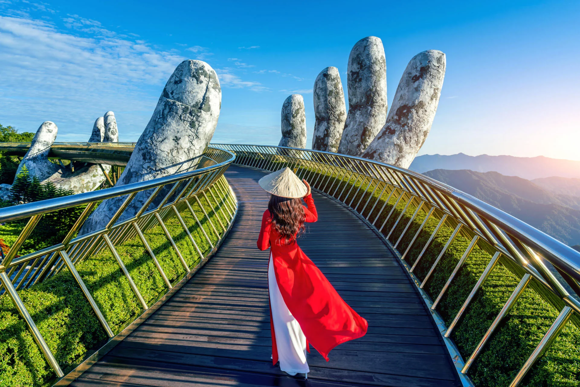 The iconic Golden Bridge (Cau Vang) at Ba Na Hills held by giant stone hands above the clouds near Da Nang Vietnam