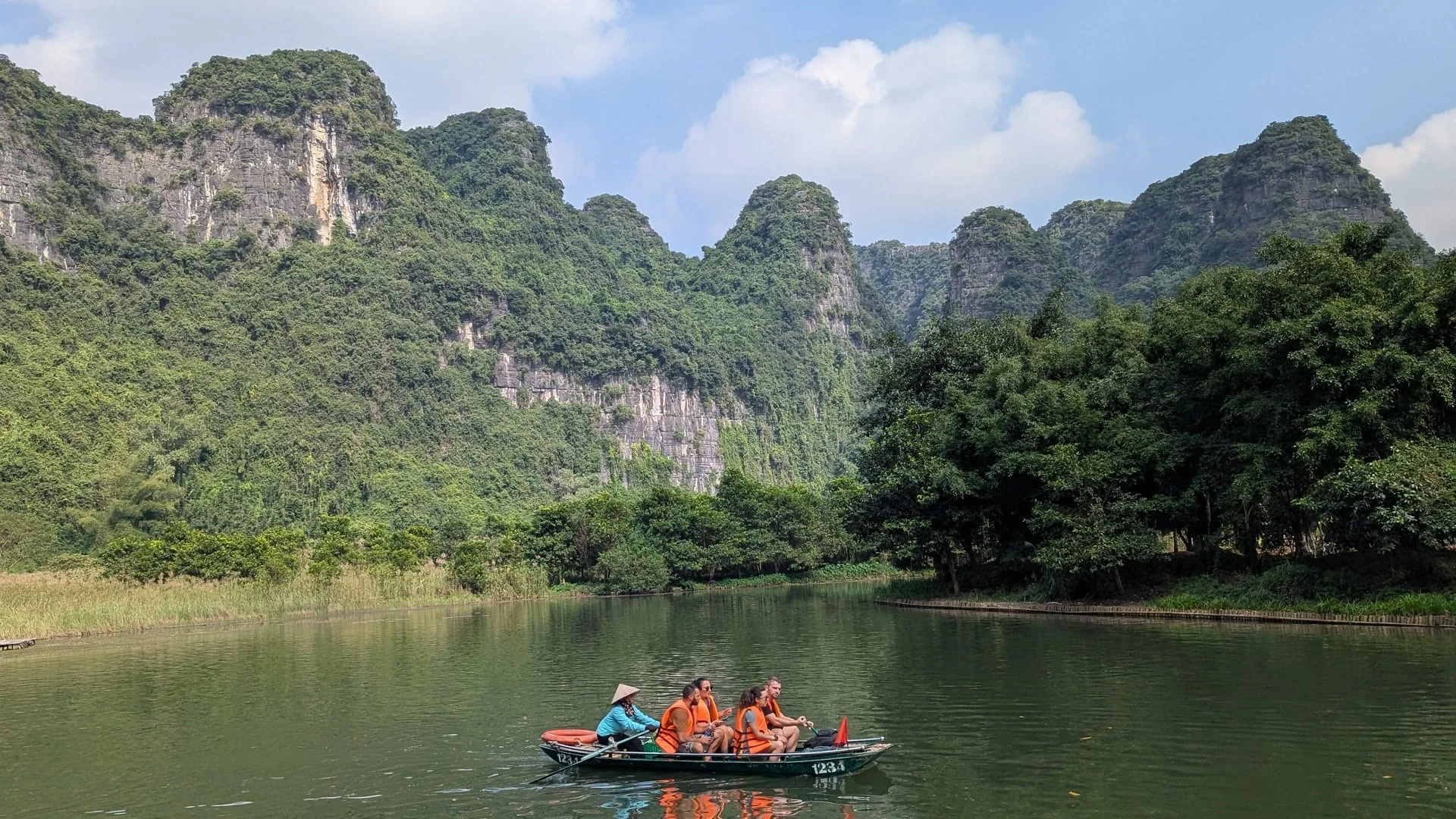Basket Boat Spinning Performance Hoi An: What to Expect & Tipping Guide 4 Tourists wearing mandatory life jackets on bamboo basket boat during coconut forest river tour in Hoi An for safety