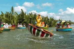 Local boatman performing 360-degree basket boat spinning with water spray halo in Hoi An Cam Thanh coconut forest