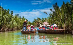 Scenic photography spot inside Hoi An coconut forest with basket boats gliding through emerald nipa palm waterway