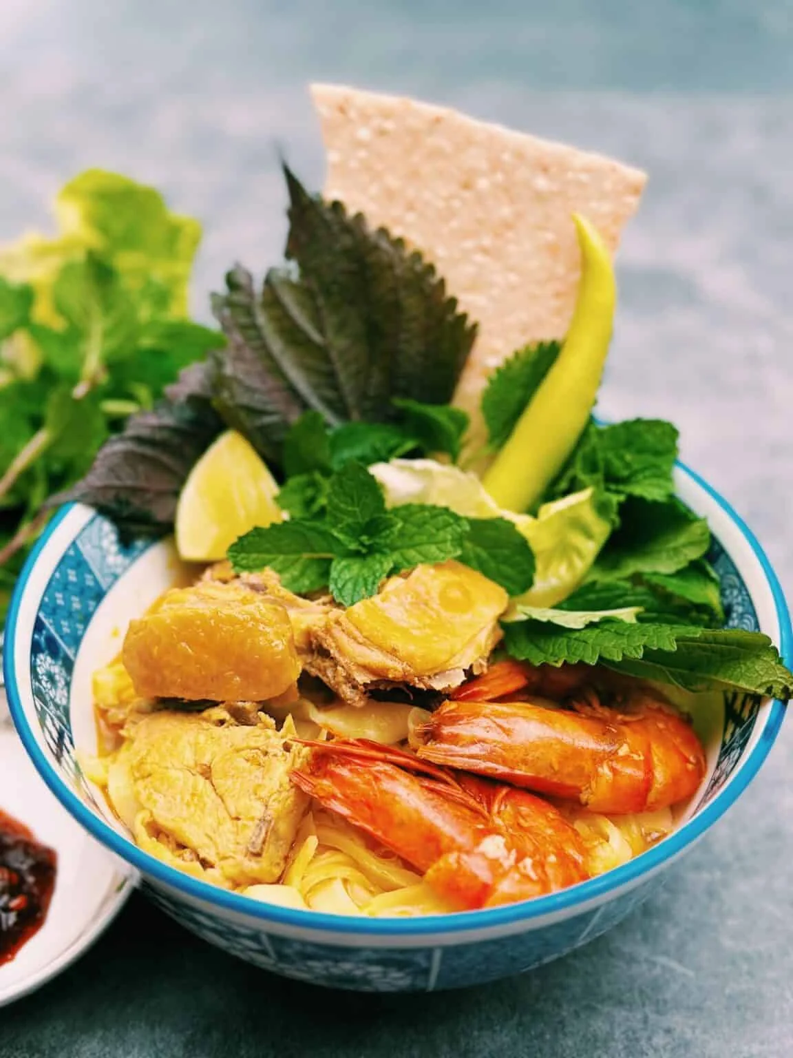 Traditional Hoi An local food specialties including Mi Quang noodles, White Rose dumplings, and Cao Lau served in Cam Thanh