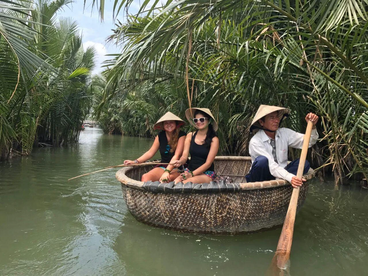 Hoi An Coconut Forest Crab Fishing & Traditional Net Casting Guide 1 Local guide demonstrating purple mangrove crab fishing with bamboo rod in the nipa palm canals of Cam Thanh Hoi An