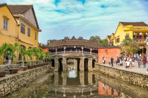 Tourists exploring the vibrant yellow-walled streets of Hoi An Ancient Town on a perfect 1-day trip from Da Nang