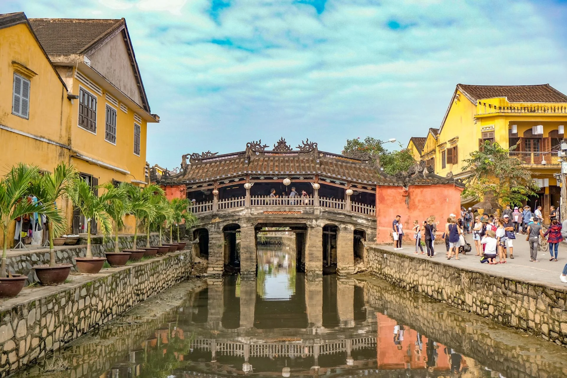 Tourists exploring the vibrant yellow-walled streets of Hoi An Ancient Town on a perfect 1-day trip from Da Nang