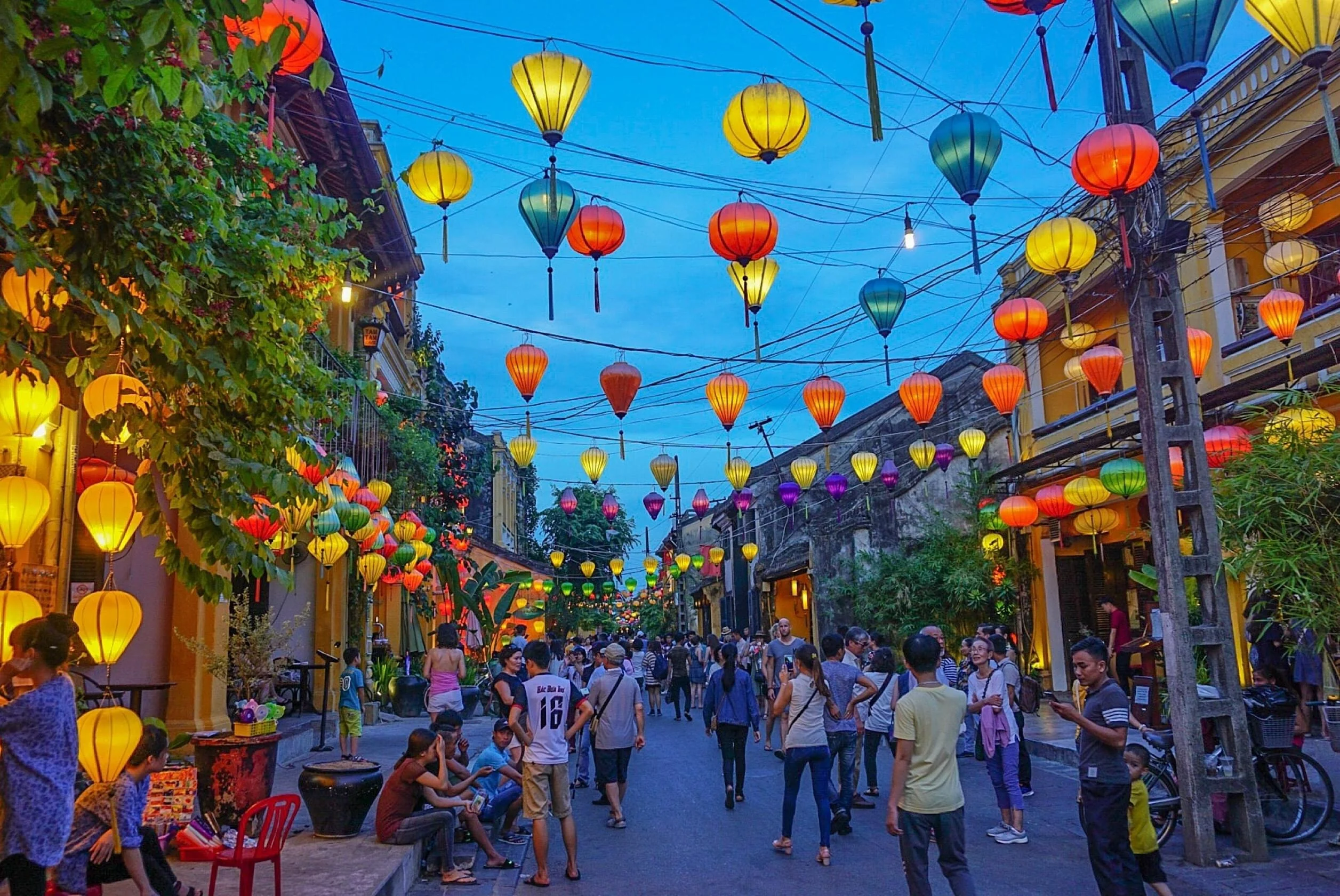Glowing silk lanterns lining the ancient yellow-walled streets of Hoi An UNESCO World Heritage Ancient Town at night