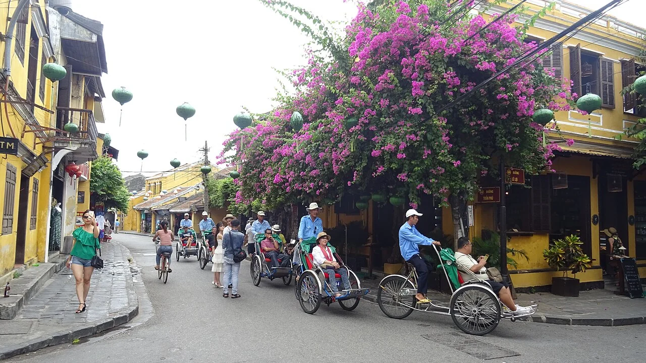 Rental bicycles parked along traditional yellow walls in Hoi An Ancient Town