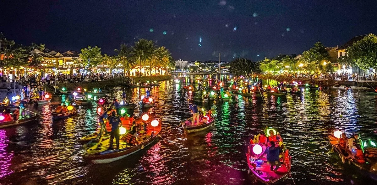 Hundreds of colorful floating paper lanterns drifting down the Thu Bon River during Hoi An Full Moon Lantern Festival