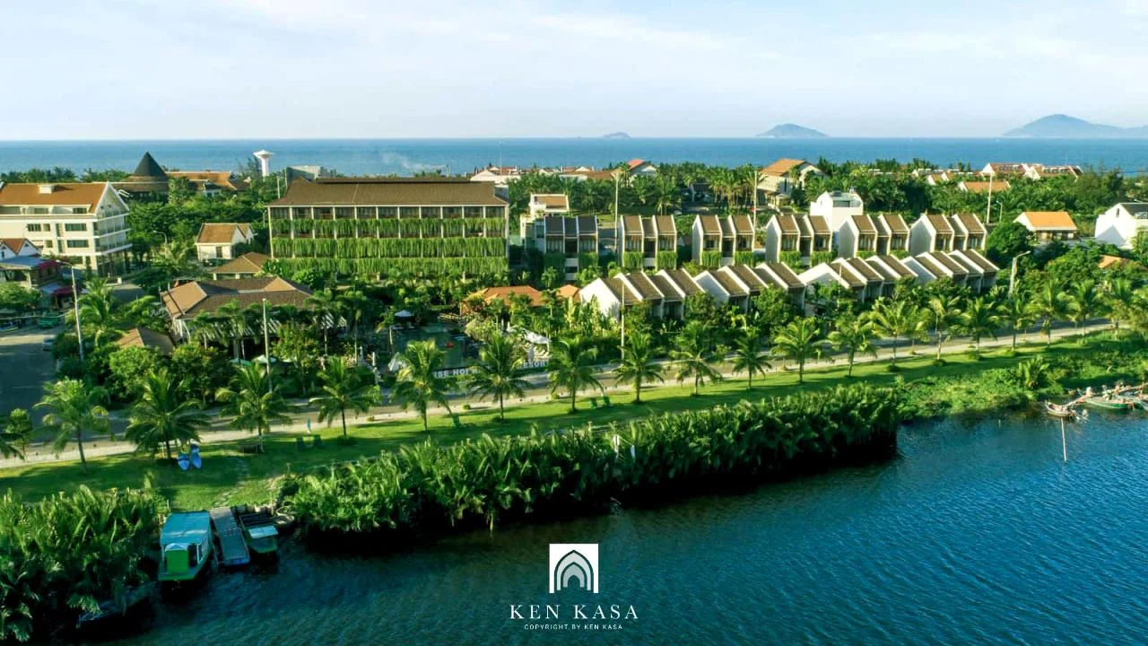 Open-air riverside dining pavilion at Lang Dua Xanh overlooking the Cam Thanh coconut forest waterway in Hoi An