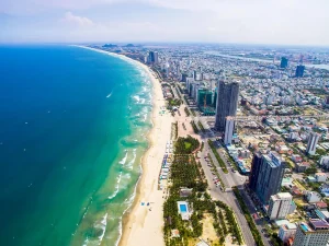 Beautiful white sand My Khe Beach in Da Nang with calm blue South China Sea waters at the starting point for Hoi An trips