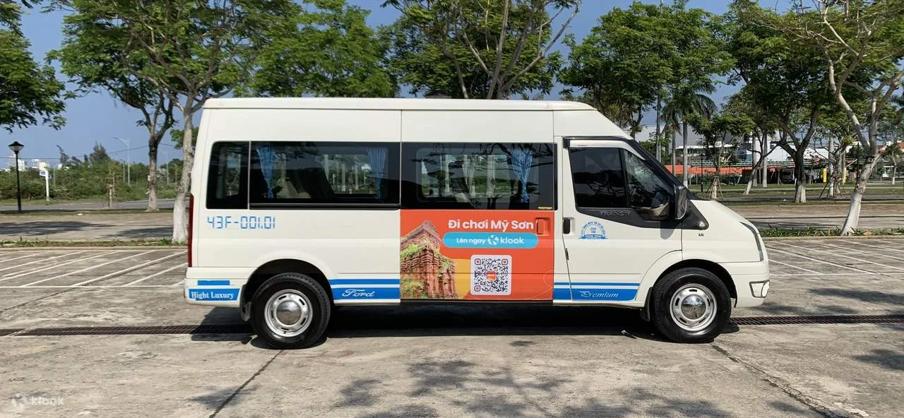 Shared tourist shuttle minivan departing Da Nang hotel for Hoi An Ancient Town with luggage storage underneath
